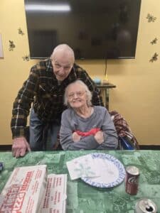Alberta and Bill smiling at the camera as they celebrate a milestone anniversary
